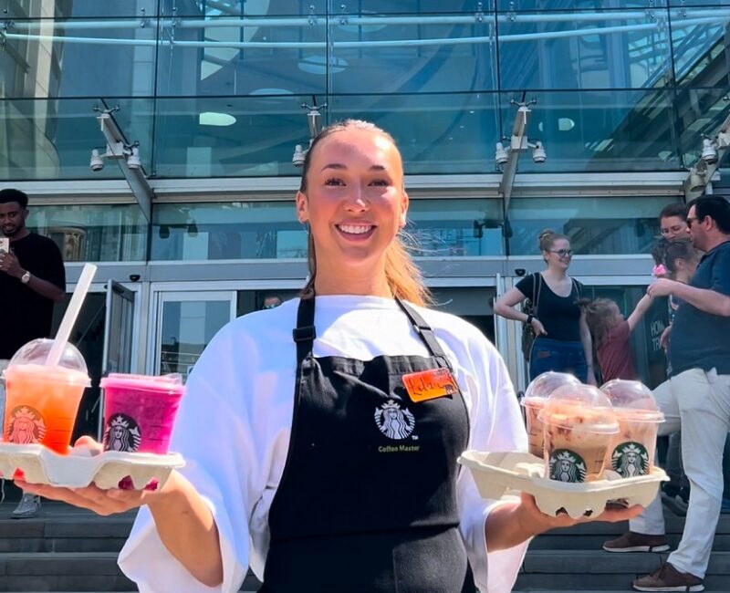 Starbucks employee outside Manchester Arndale holding a selection of ices drinks