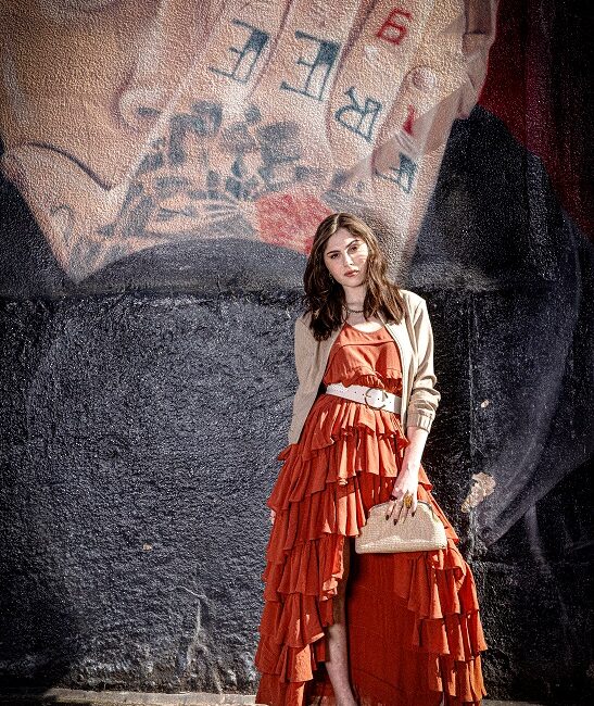 Woman in a long ruffled red dress.