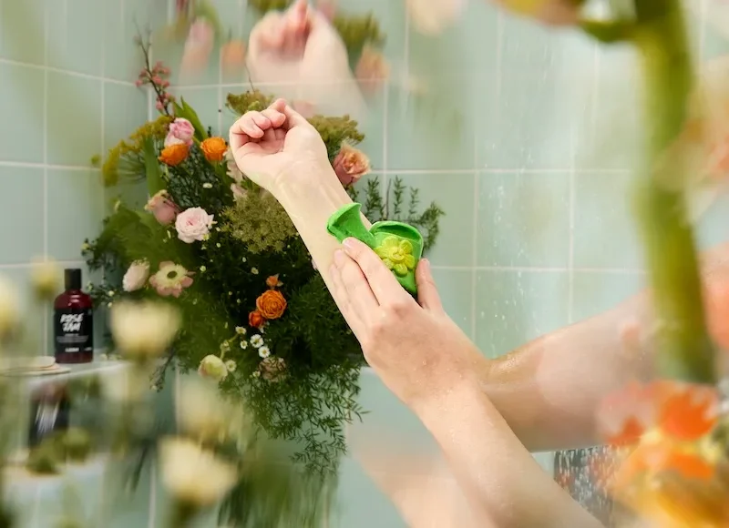 Someone pictured using a Lush product in the shower