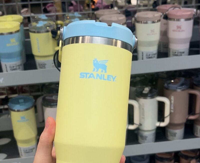 Yellow Stanley tumbler with blue lid.